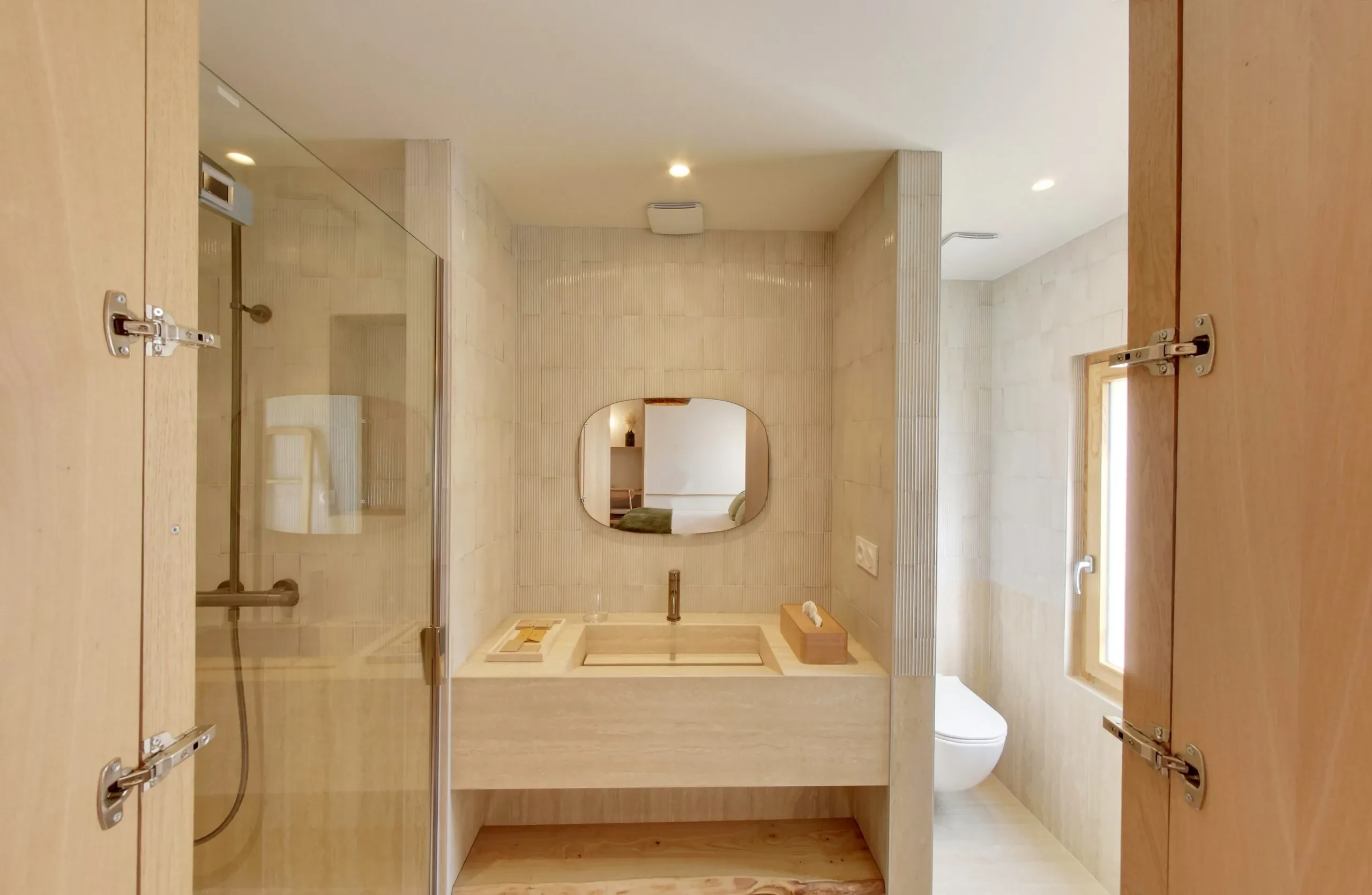Salle de bain moderne avec douche et lavabo.
